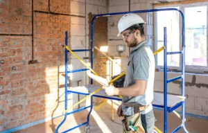 San Mateo Scaffolding Rental worker using indoor mobile scaffold for construction project